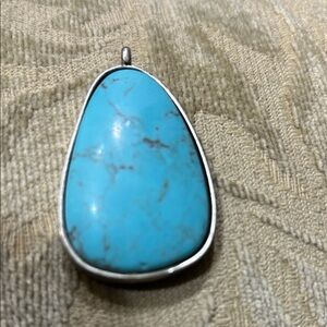 Navajo sterling silver pendant with hand-stamped designs
  Necklace